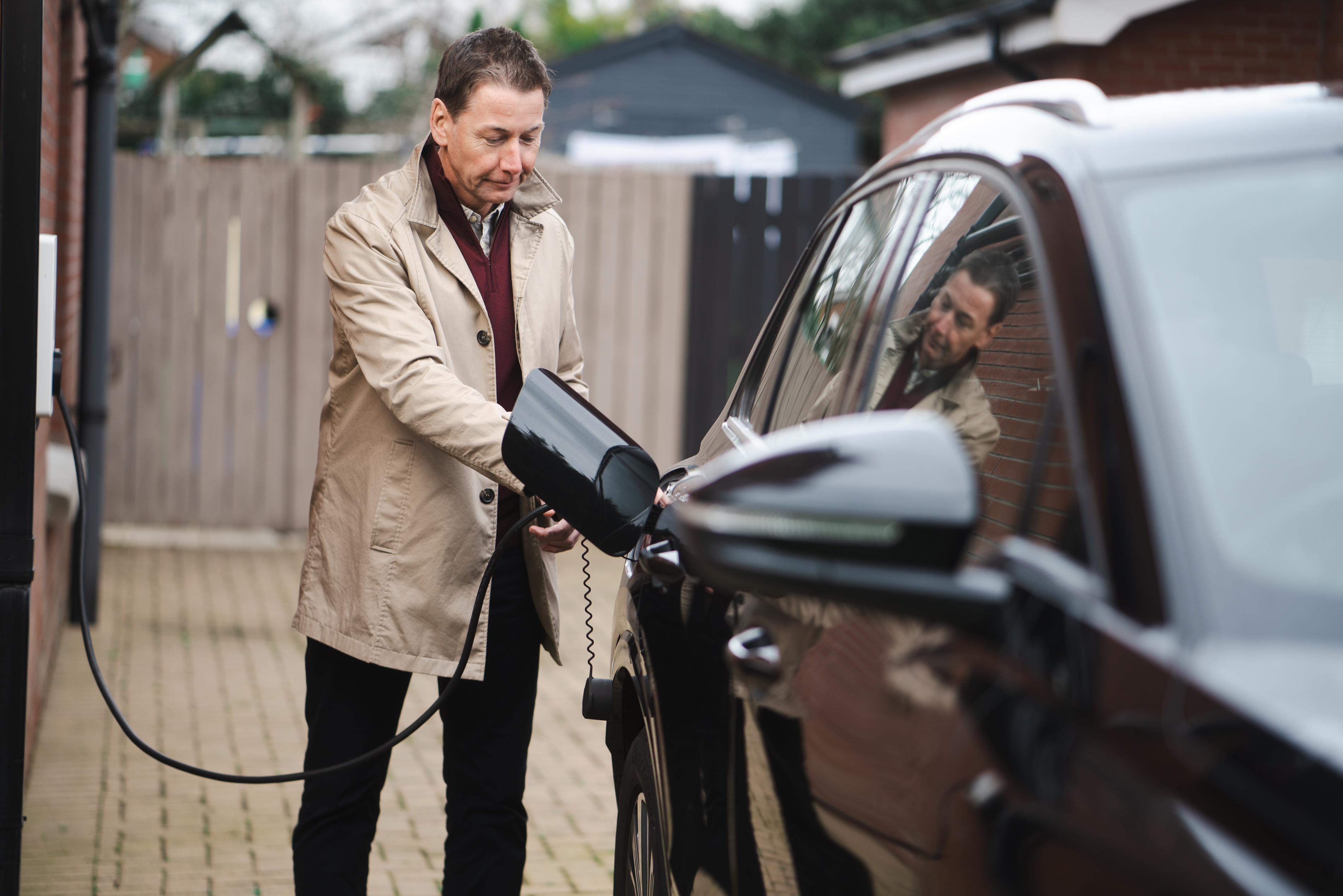 man-charging-electric-vehicle.jpg