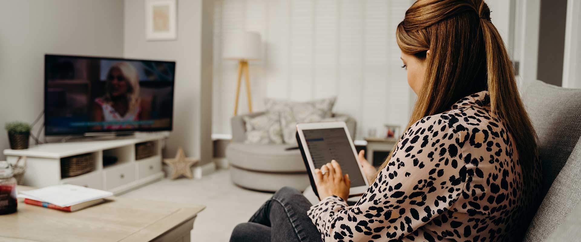 Woman-using-an-ipad-and-watching-tv.jpg