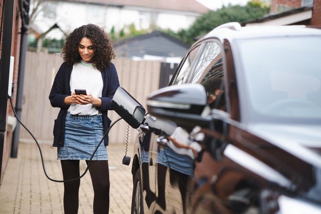 Woman monitoring her EV charging app